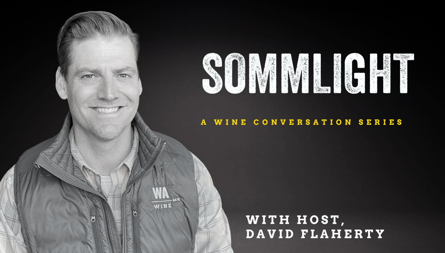 black and white image of a man wearing a button up shirt and vest, smiling at the camera. "Sommlight A Wine Conversation with Host, David Flaherty" is over the dark background.