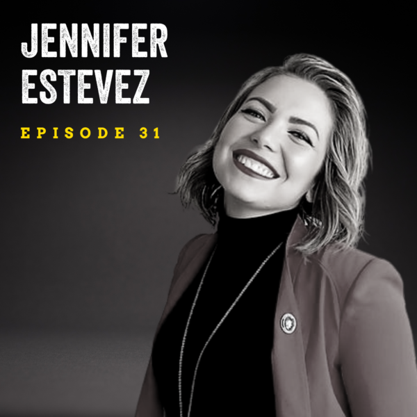 black and white image of a woman (Jennifer Estevez) with shoulder-length hair smiling at the camera, wearing a blazer and dark turtleneck. Jennifer Estevez, episode 31 is overlaid in the top left corner